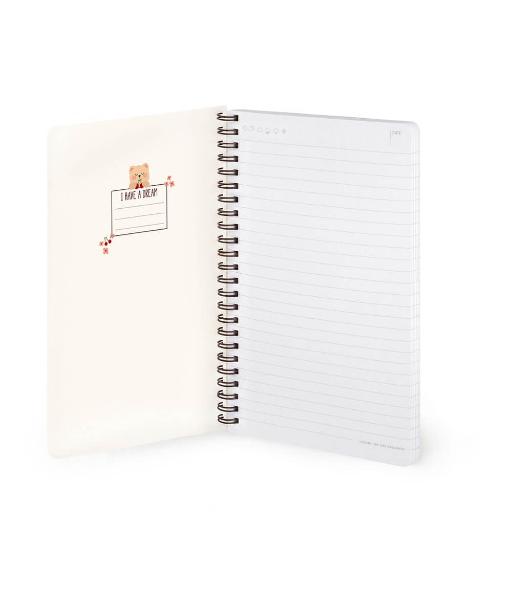 Cahier A5 Ourson de Legami ouvert sur ses pages lignées et sa couverture intérieure, sur fond blanc