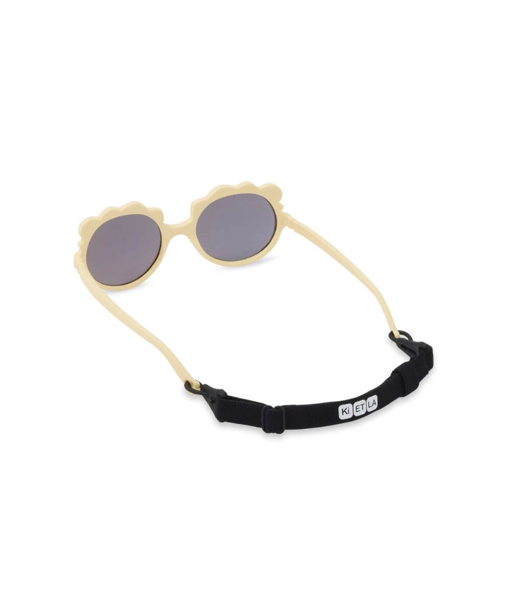 Lunettes Lion Couleur Vanille de la marque KI ET LA, sur fond blanc avec le cordon sur les branches