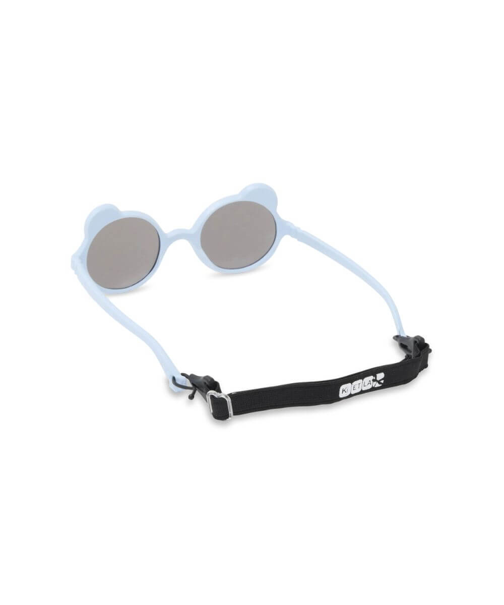 Lunettes Ourson Couleur Bleu clair de la marque KI ET LA, sur fond blanc avec le cordon sur les branches
