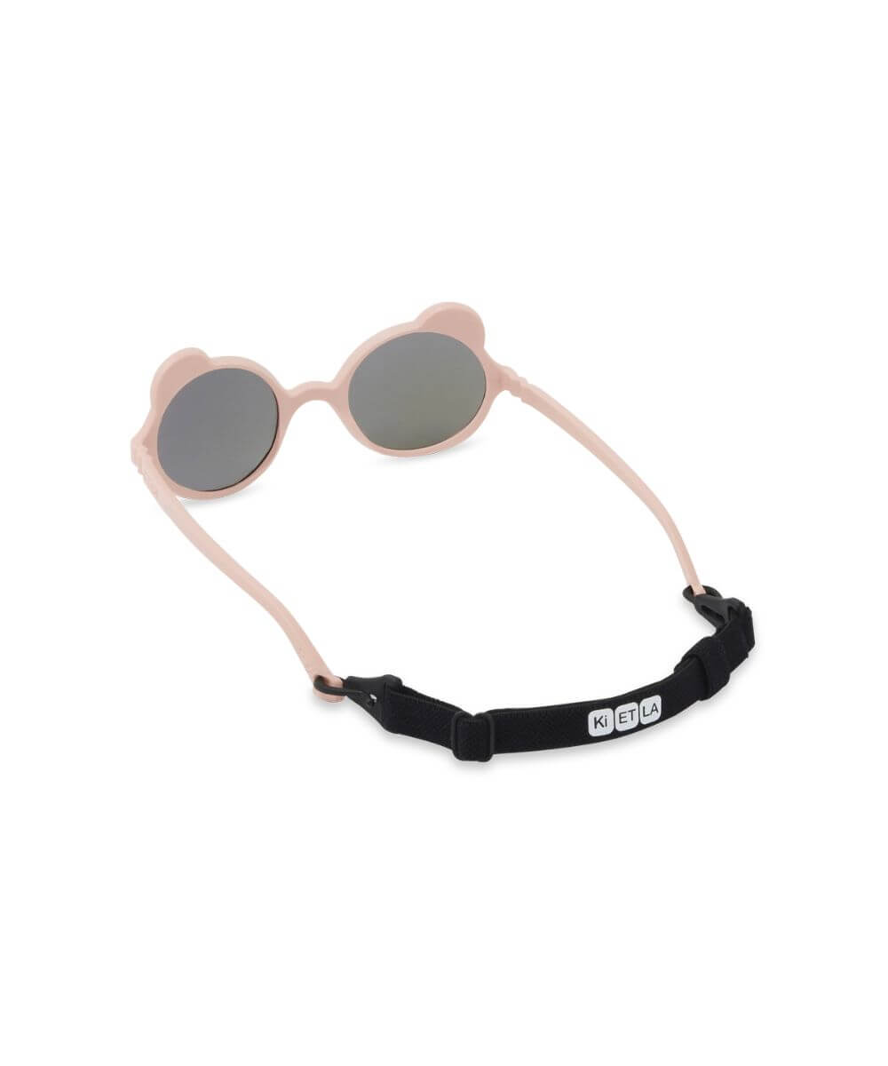Lunettes Ourson Couleur Rose Pêche de la marque KI ET LA, sur fond blanc avec les dragonnes sur les branches