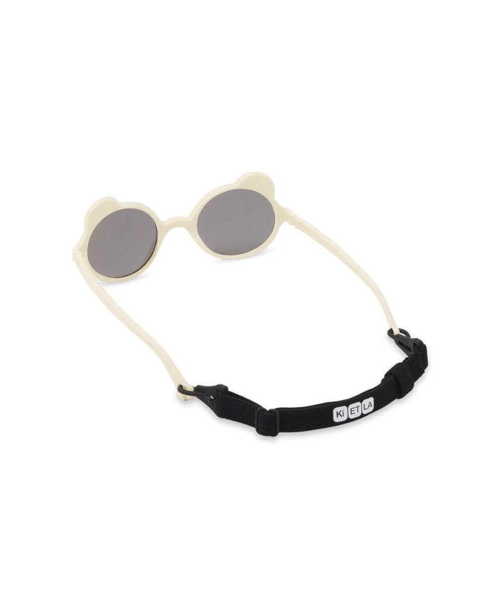 Lunettes Ourson Couleur Crème de la marque KI ET LA, sur fond blanc avec le cordon sur les branches