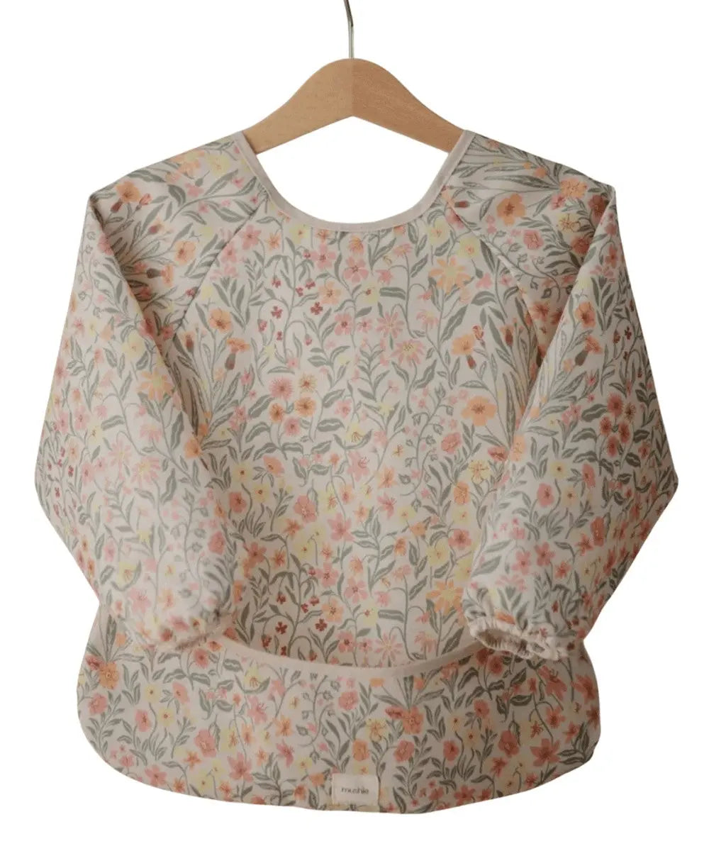 Détail du motif Pastel Blooms du Bavoir à manches longues de Mushie