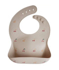 Bavoir en silicone alimentaire souple avec poche imprime cerises Mushie