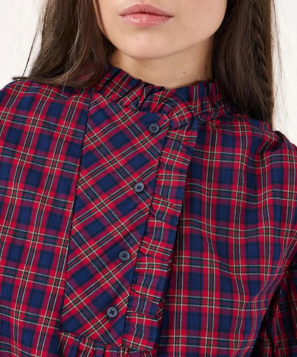 Blouse ample en coton tartan rouge et marine celeste avec col montant a volants et manches bouffantes.