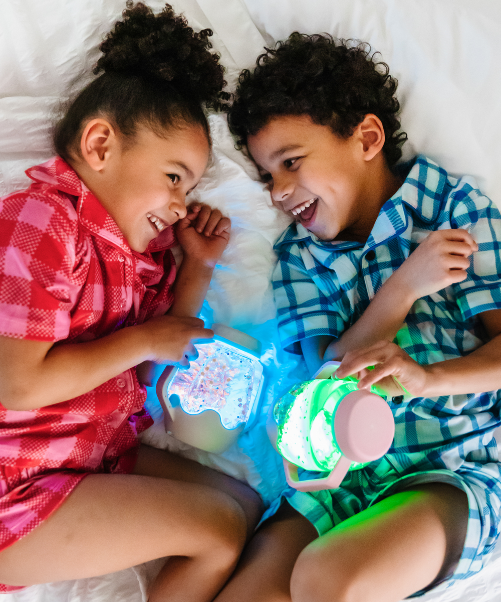 Enfant découvrant le bocal sensoriel lumineux rose Bubblegum Glo Pals