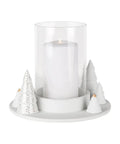 Photophore en porcelaine blanche Räder avec petits sapins sculptes et touches dorées autour du verre clair.