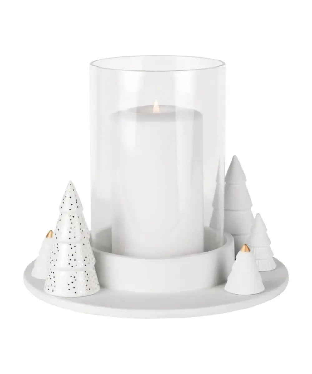 Photophore en porcelaine blanche Räder avec petits sapins sculptes et touches dorées autour du verre clair.
