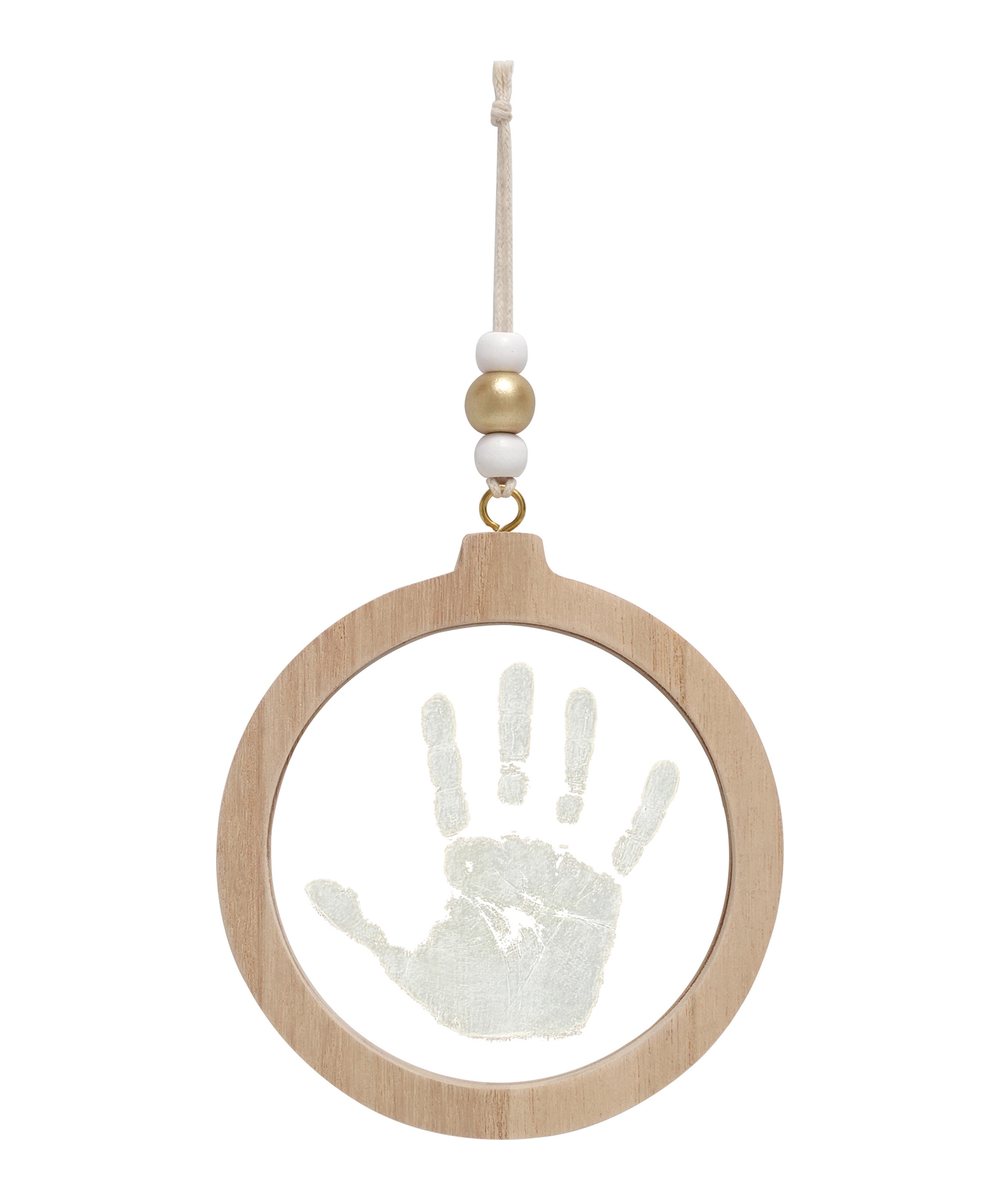 Boule de Noël empreinte transparente de la marque Petit Artichaut, sur fond blanc