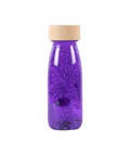 Bouteille sensorielle Float violette avec éléments flottants de Petit Boum