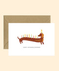 Carte de vœux anniversaire représentant un teckel en fête de la marque française All The Ways To Say.