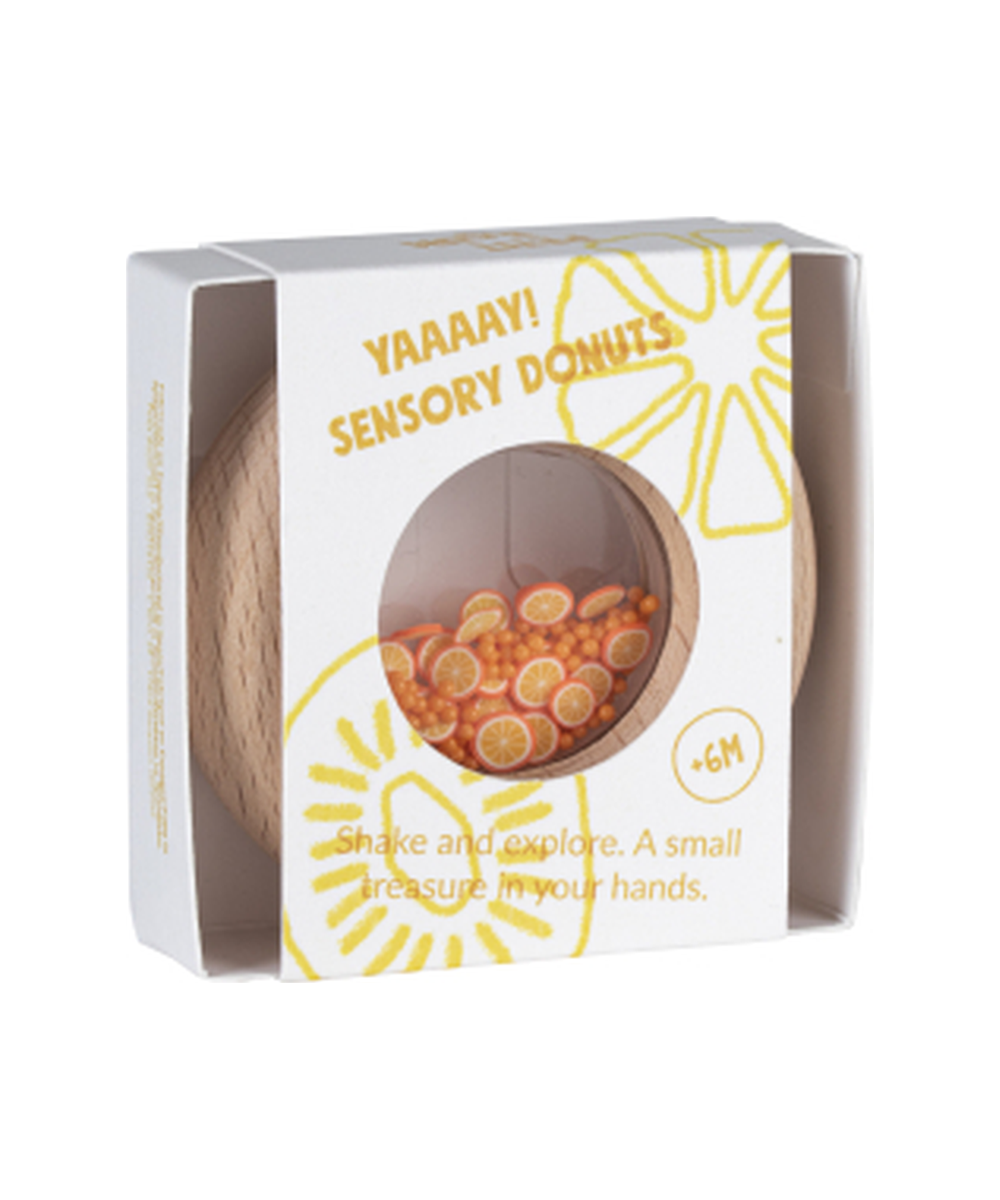 Boîte du hochet sensoriel Donut Oranges de la marque Petit Boum, sur fond blanc