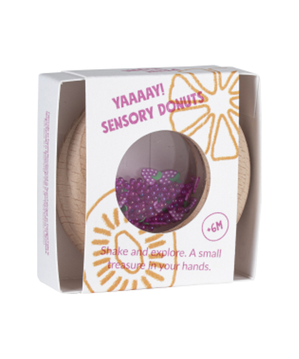 Boîte du hochet sensoriel Donut Raisins de la marque Petit Boum, sur fond blanc