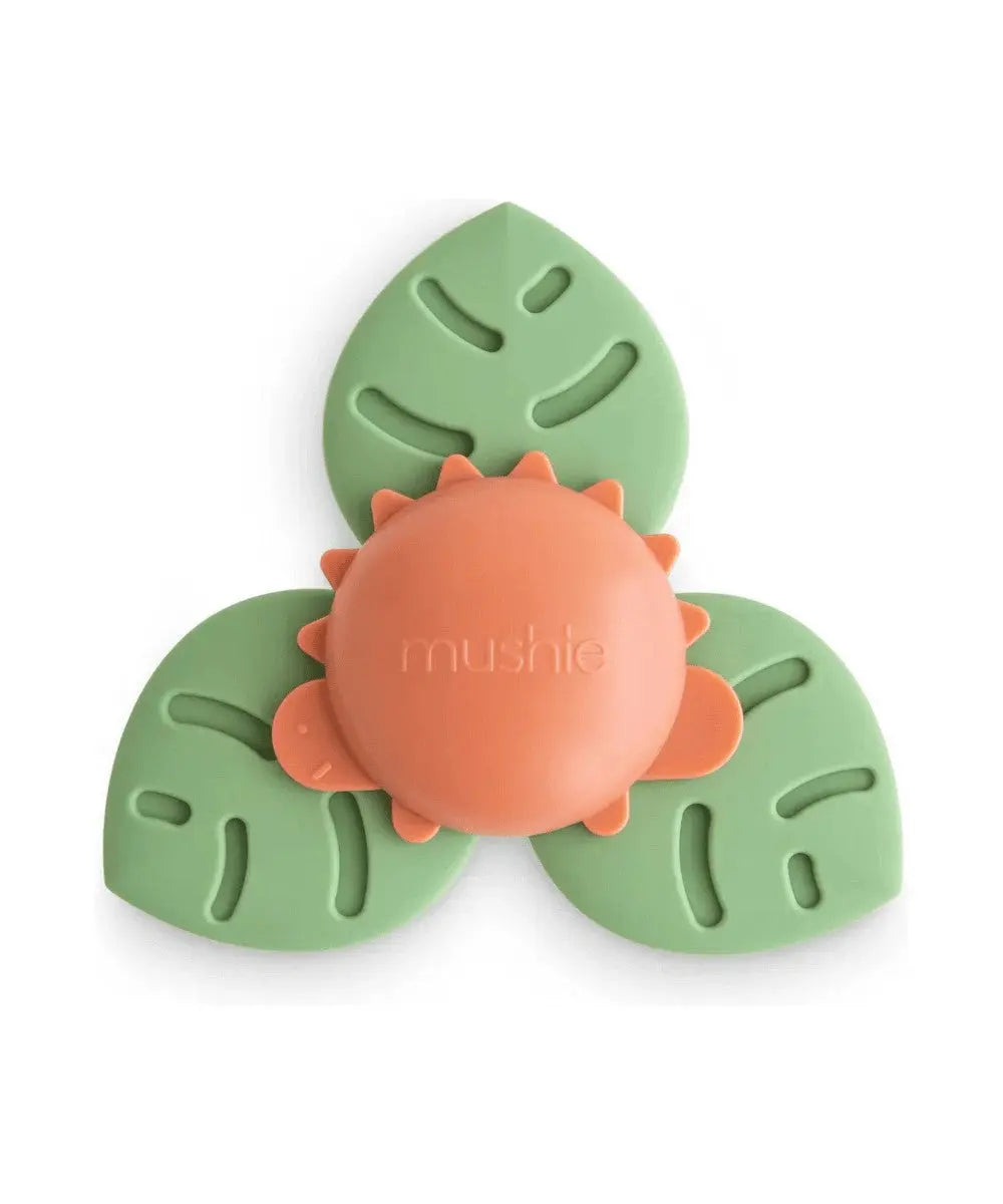 Jouet d'éveil ventouse Dinosaure de Mushie sur un fond blanc