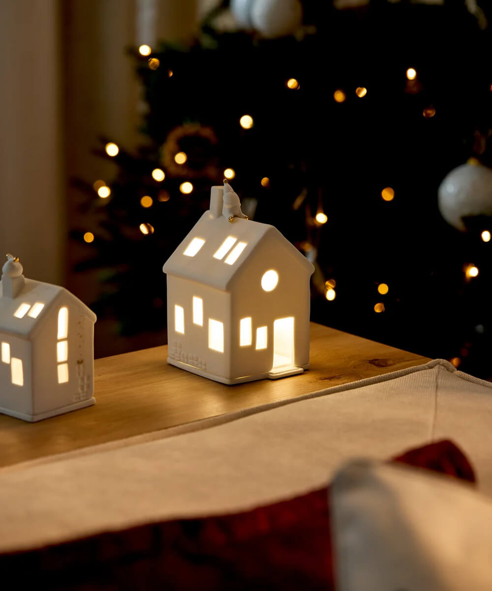 Maisons photophores Räder illuminées dans un décor de Noël, avec En attendant Rudolf à droite