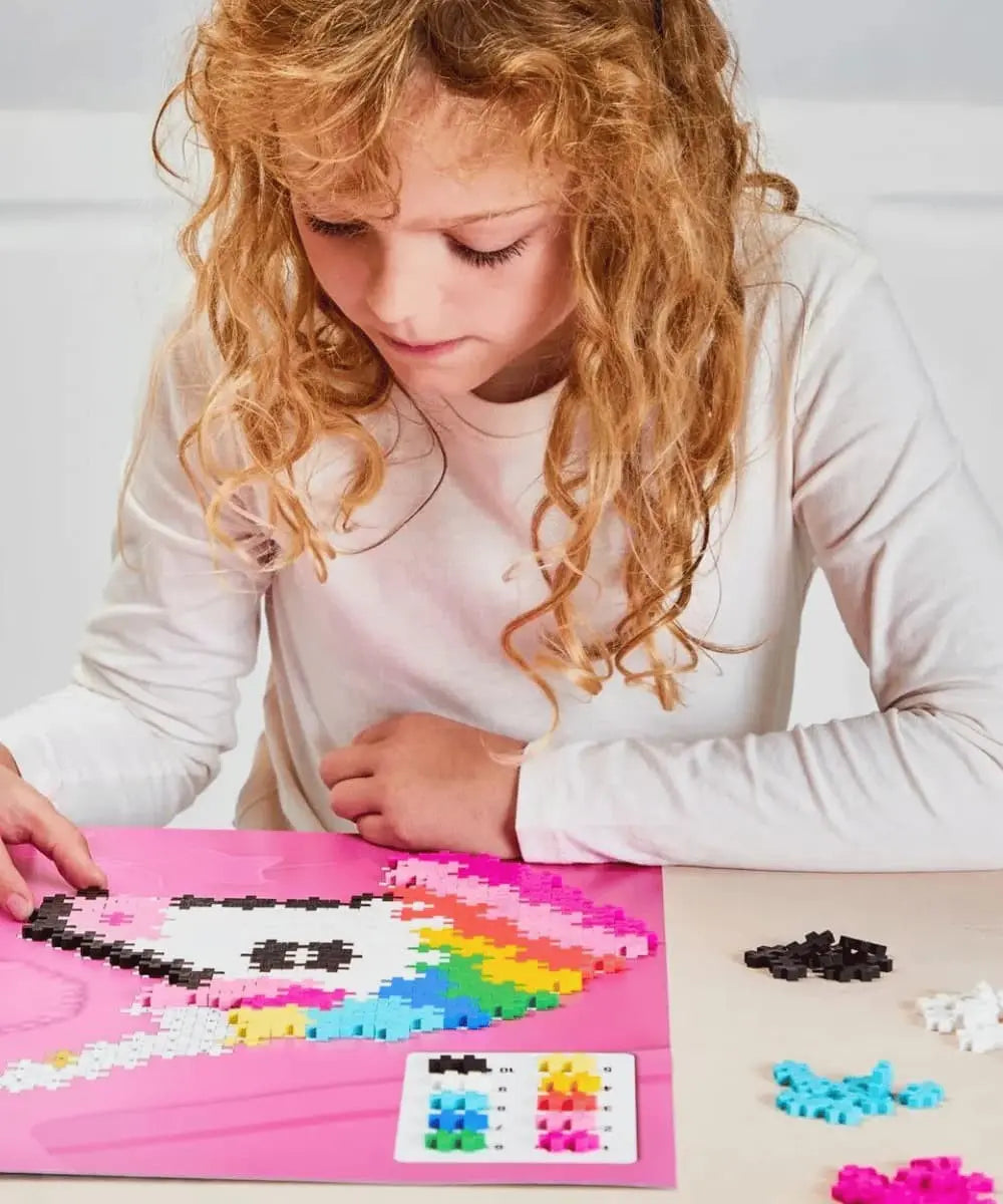 Enfant en train de réaliser le Puzzle Licorne 250 pièces de Plus-Plus