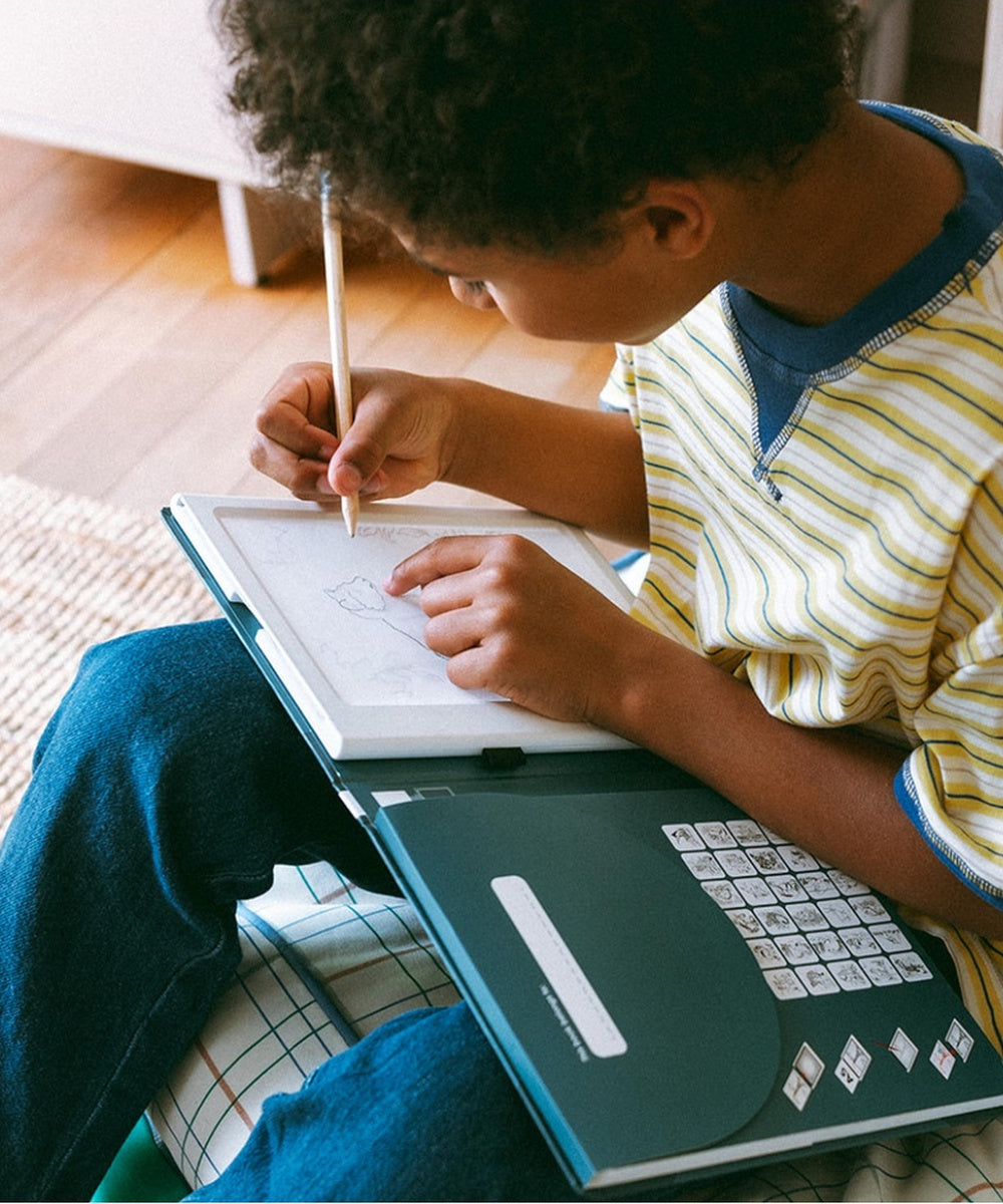 Enfant suivant les contours d’un animal sur la tablette lumineuse