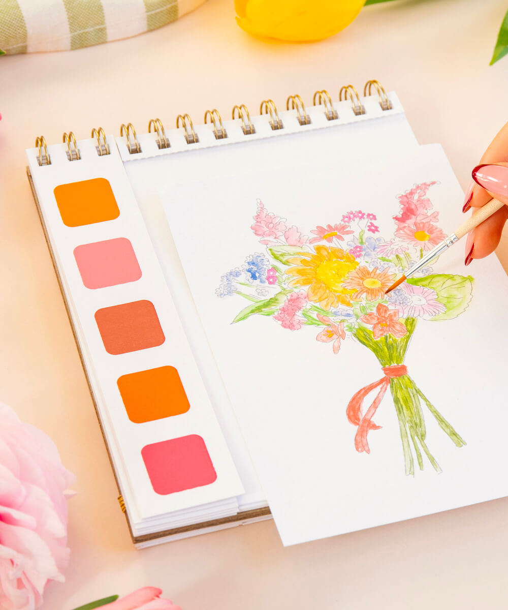 Illustration florale du Travel Book Secret Garden de La Petite Épicerie, peinte à l'aquarelle avec sa palette intégrée