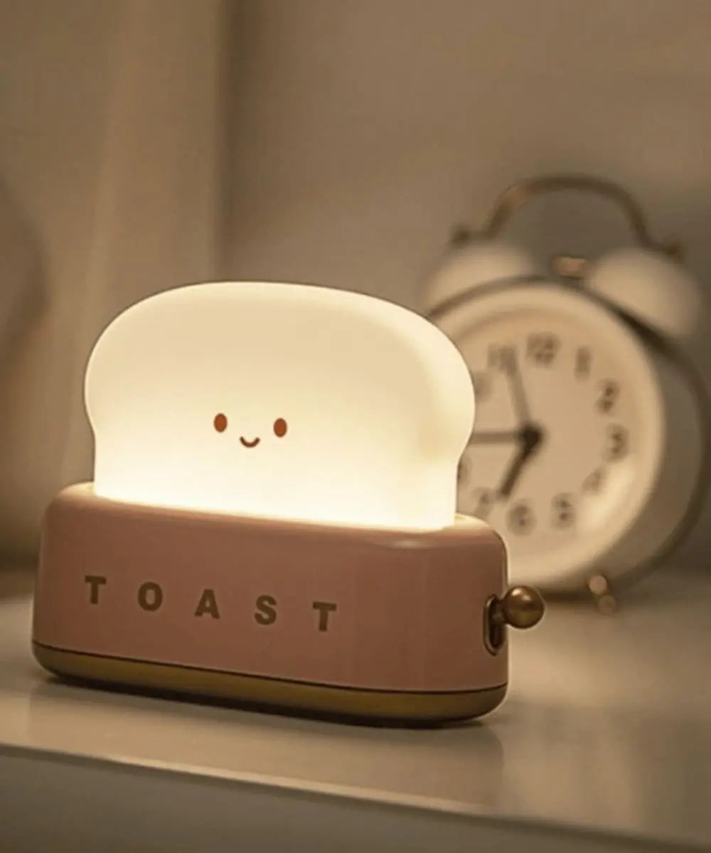 Veilleuse rechargeable Toaster Rose de Mary's posée sur une table de chevet